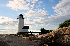 Annisquam Harbor Light as Sun Sets Over Rocky Shore